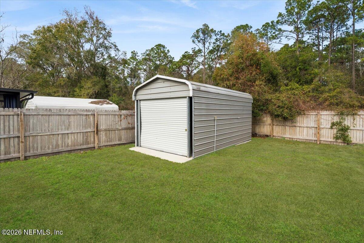 425 3rd Street West Baldwin, FL 32234 - Photo 34 of 47 a white house that has tree in front of it