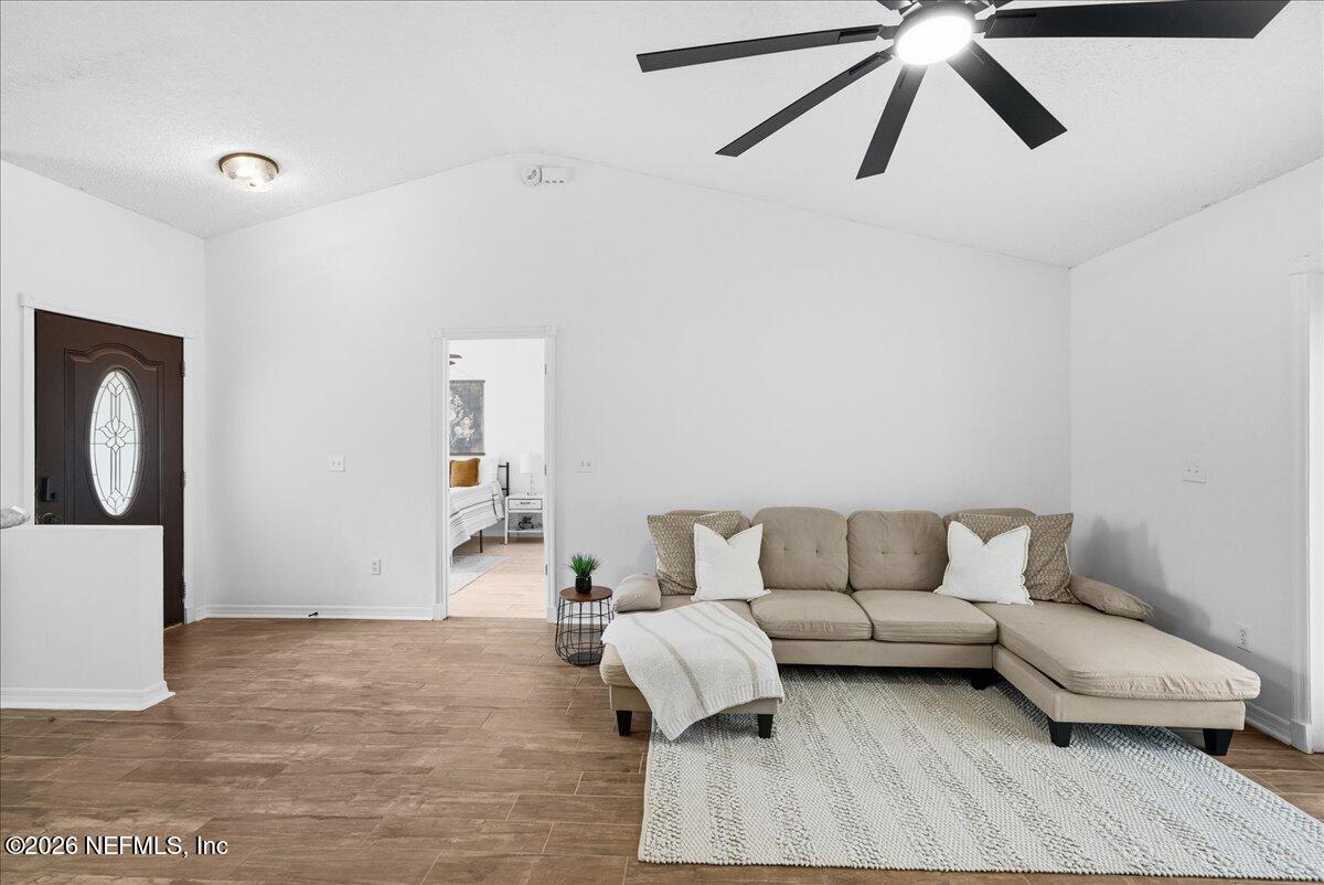 425 3rd Street West Baldwin, FL 32234 - Photo 5 of 47 a living room with furniture and a rug