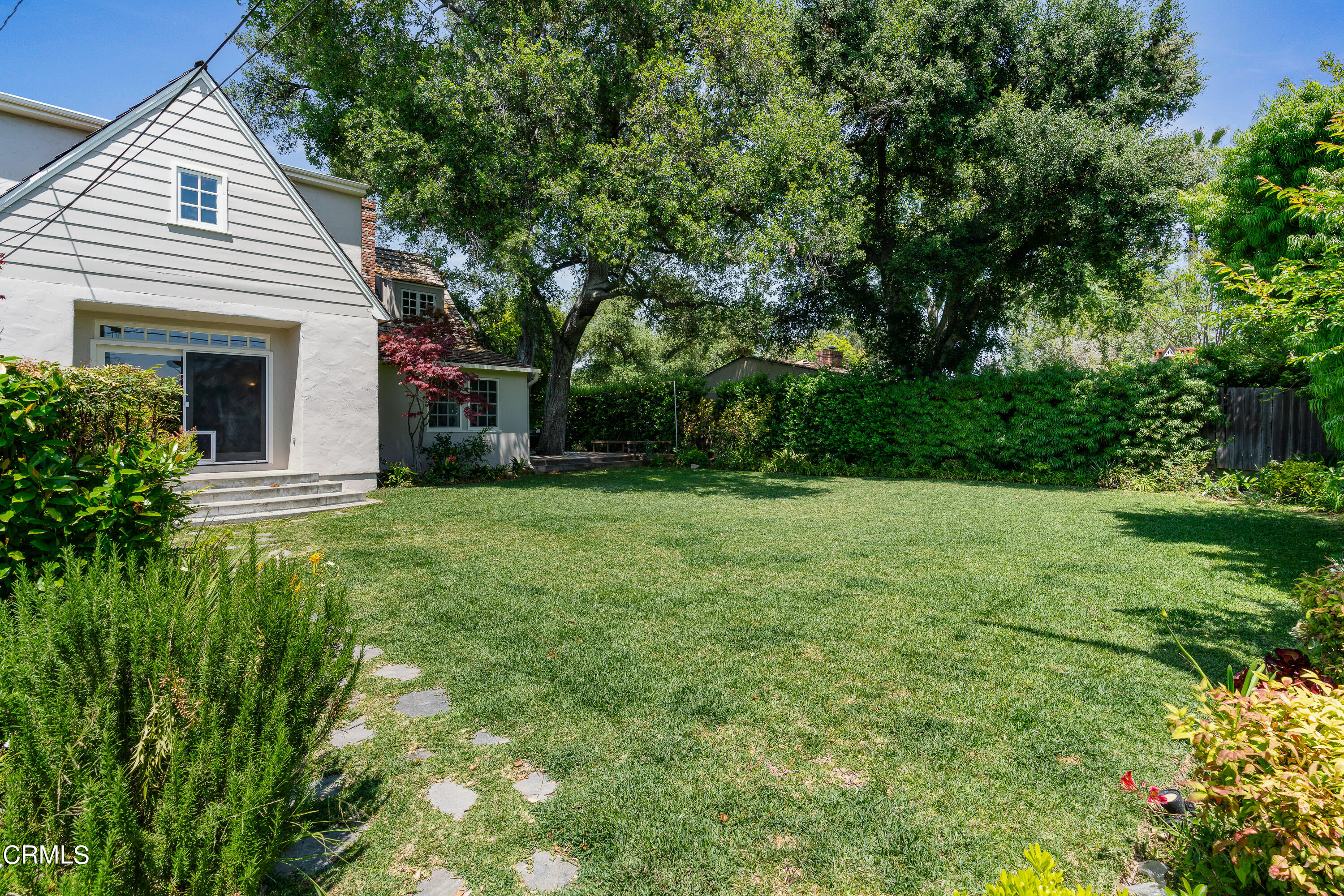 3642 Yorkshire Road Pasadena, CA 91107 - Photo 31 of 37 a view of a white house with a yard and potted plants