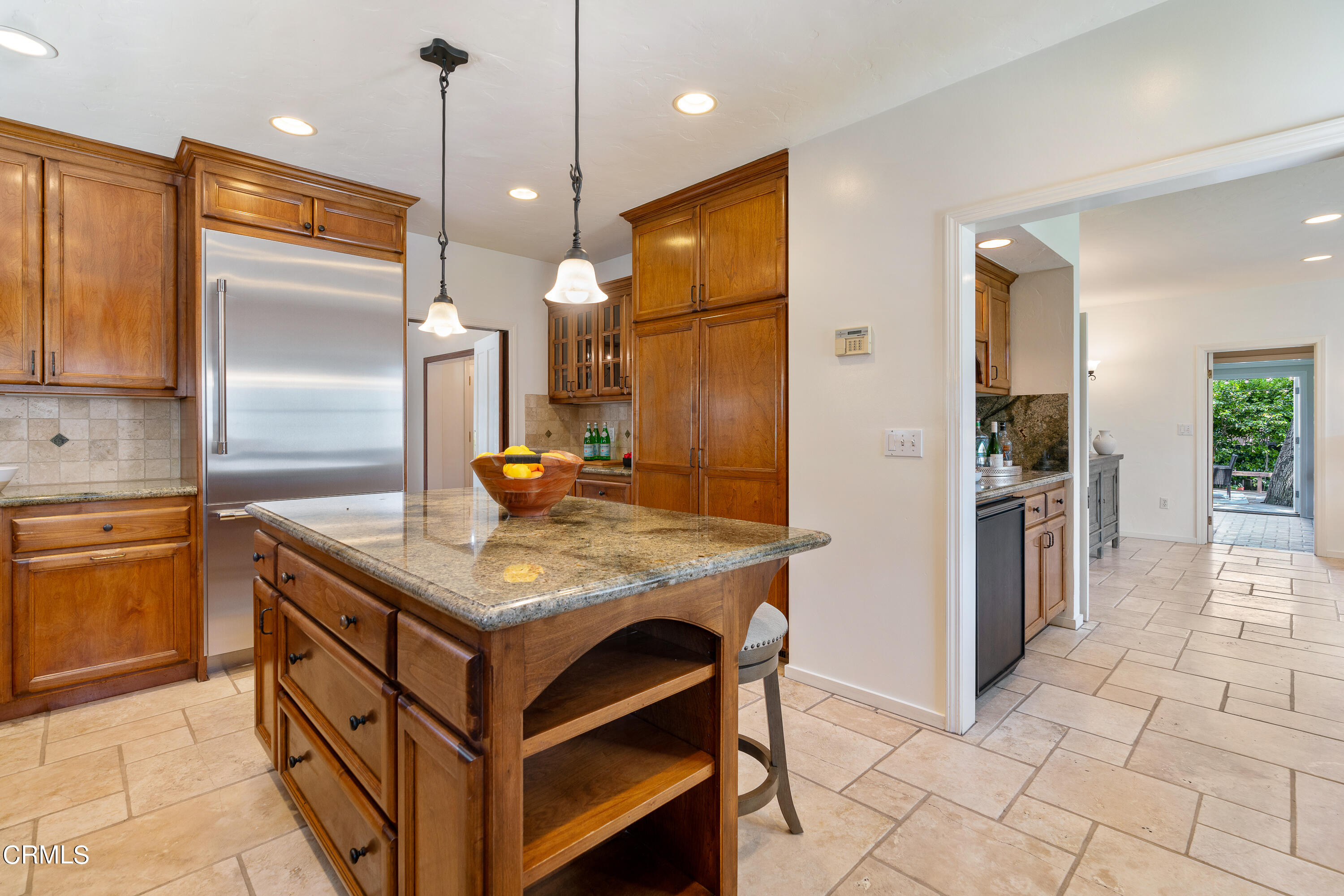 3642 Yorkshire Road Pasadena, CA 91107 - Photo 10 of 37 a kitchen with kitchen island granite countertop wooden cabinets and a refrigerator