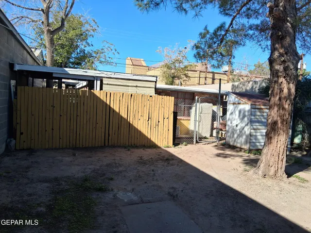 a view of a house with a wooden fence