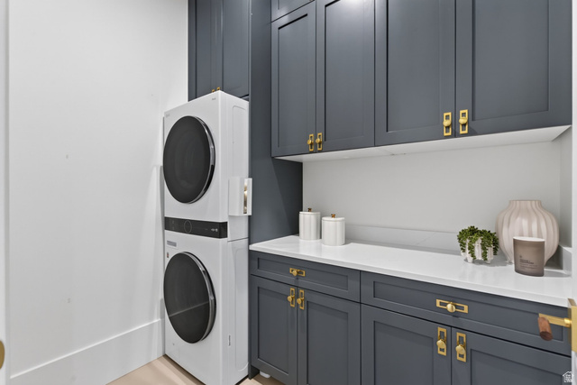 12308 Mariah Circle Draper, UT 84020 - Photo 191 of 293 Guest House Laundry area featuring stacked appliances, dark cabinetry, light countertops, and a white backsplash