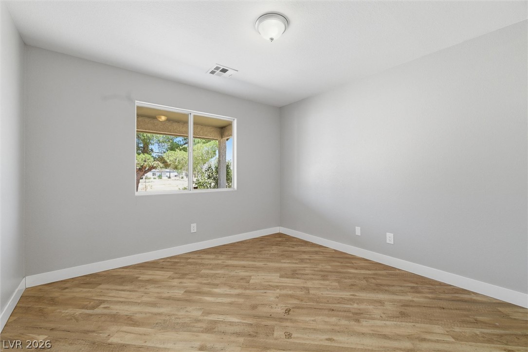 2780 West Simkins Road Pahrump, NV 89060 - Photo 31 of 40 Warm wood-look flooring and generous window views define this inviting space.