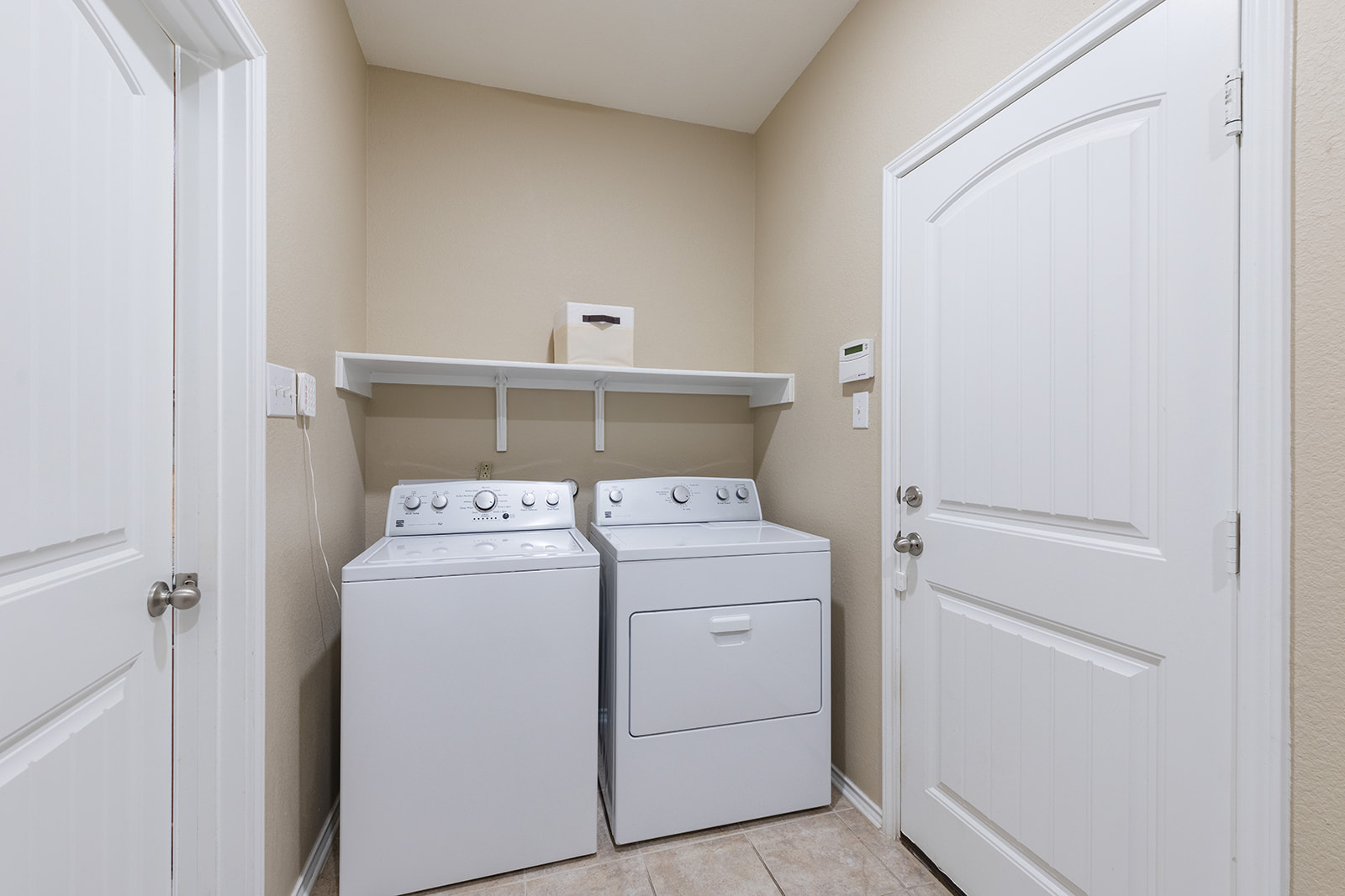 437 Sheepshank Drive Georgetown, TX 78633 - Photo 14 of 22 Functional utility space with convenient laundry appliances and storage shelf located just off the kitchen next to the garage door.