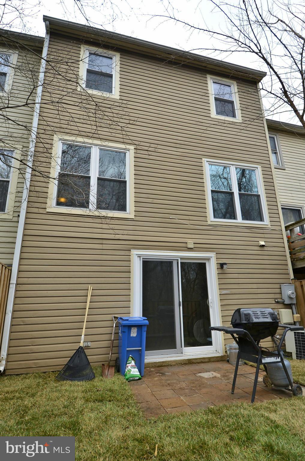 35 Kinsman View Circle Silver Spring, MD 20901 - Photo 28 of 30 a front view of a house with garden and chairs