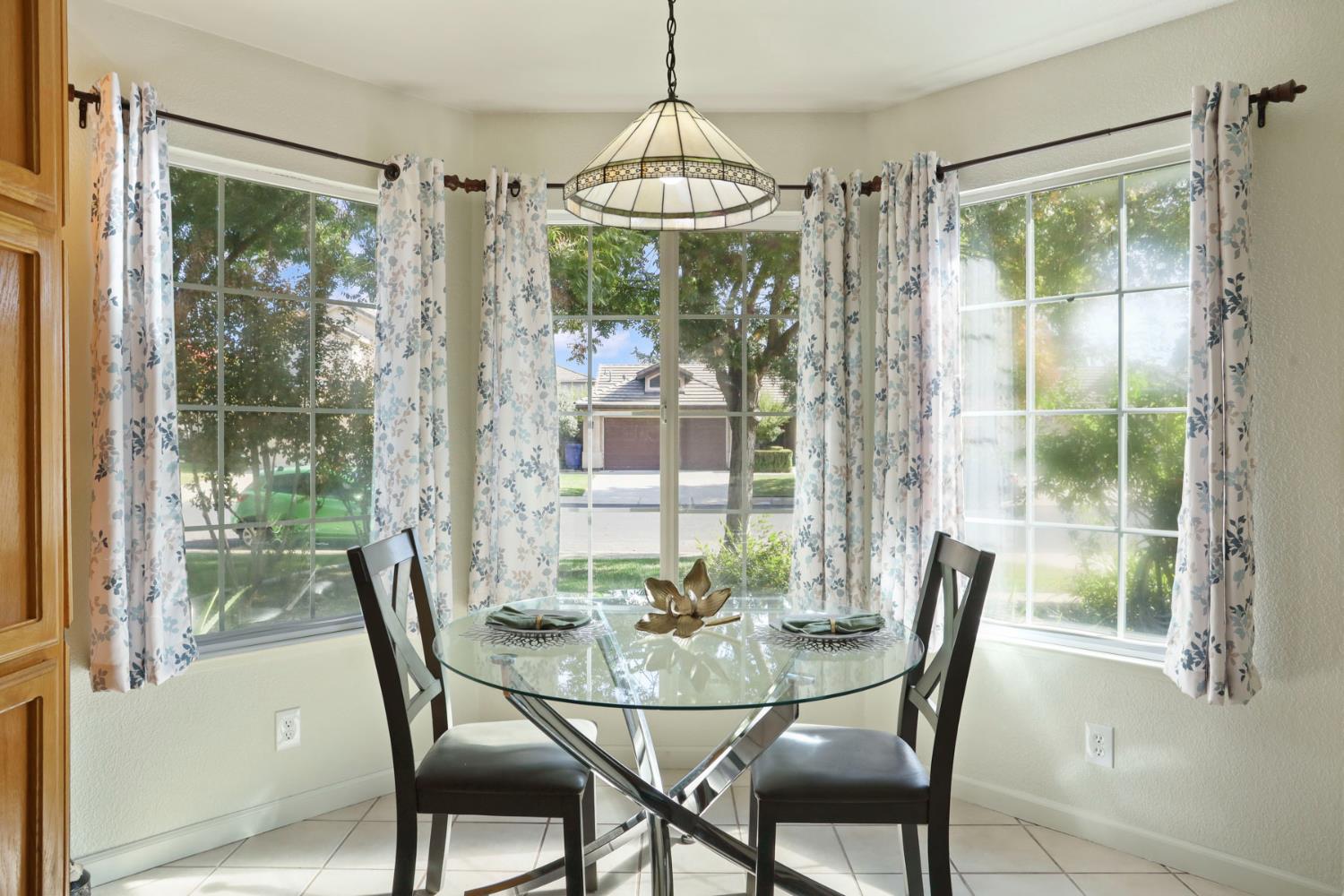 1505 Dreyfus Lane Modesto, CA 95355 - Photo 11 of 25 a view of a dining room with furniture window and outside view