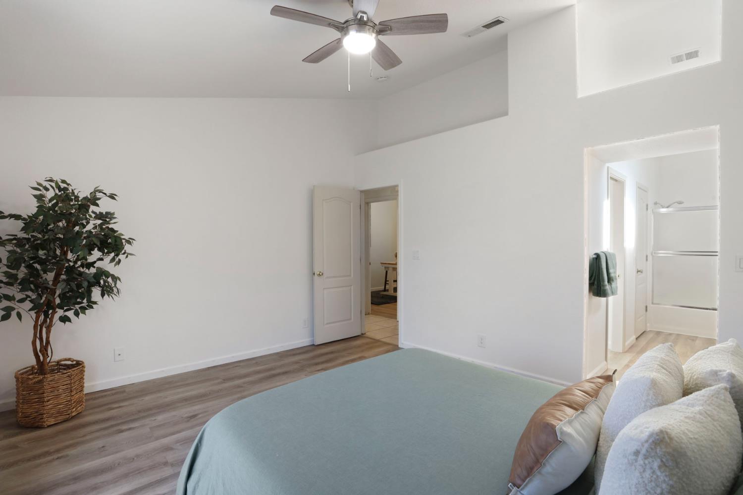 1505 Dreyfus Lane Modesto, CA 95355 - Photo 19 of 25 a bedroom with a bed and a potted plant