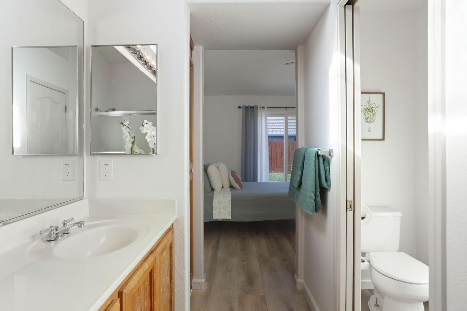 1505 Dreyfus Lane Modesto, CA 95355 - Photo 21 of 25 a en suite bathroom with a granite countertop sink a toilet and a mirror
