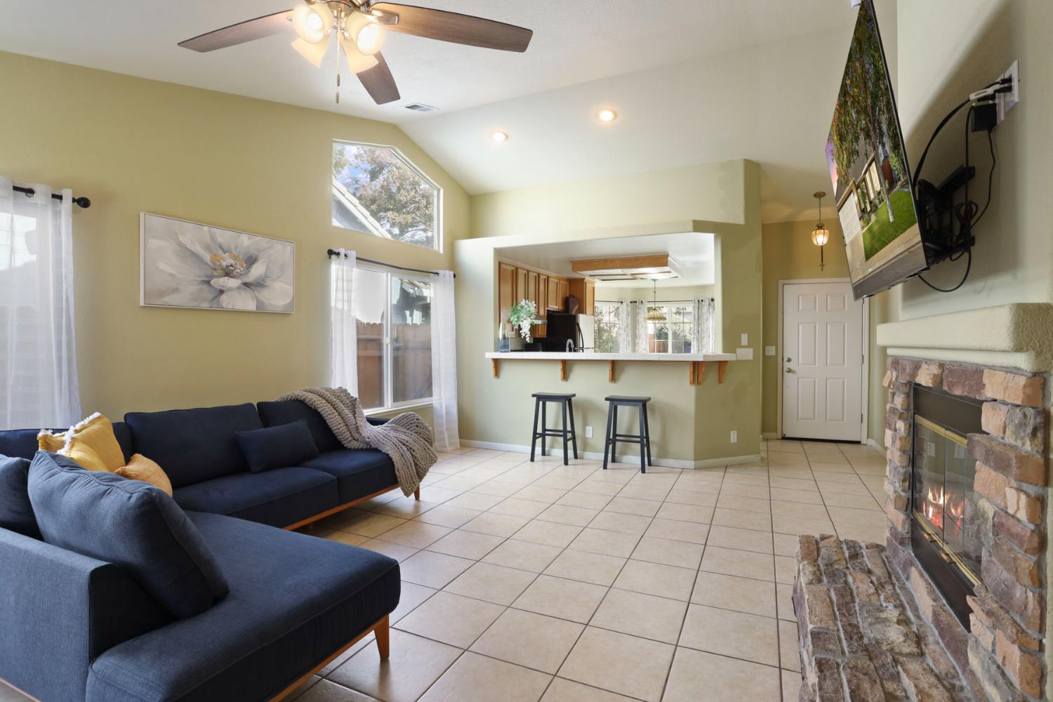 1505 Dreyfus Lane Modesto, CA 95355 - Photo 8 of 25 a living room with furniture and a flat screen tv