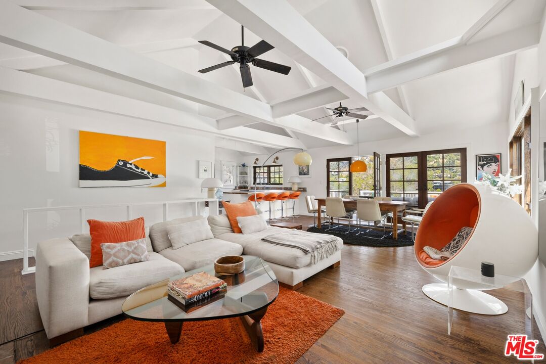 a living room with furniture a rug and a flat screen tv