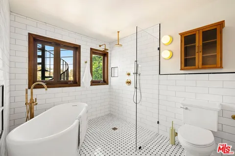 a bathroom with a bathtub and a shower