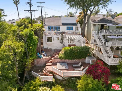a view of a house with backyard sitting area and swimming pool