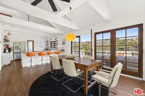 a living room with furniture and floor to ceiling windows