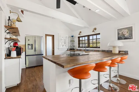 a dining hall with a dining table and chairs with wooden floor