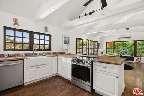 a open kitchen with stainless steel appliances granite countertop a stove and a sink