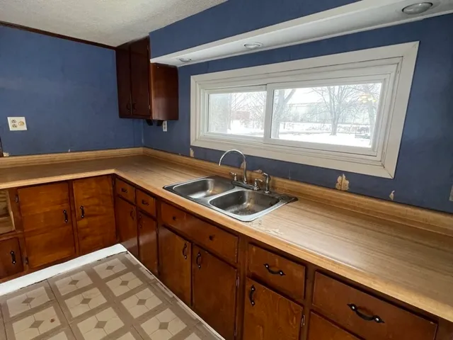 a kitchen with a sink and cabinets