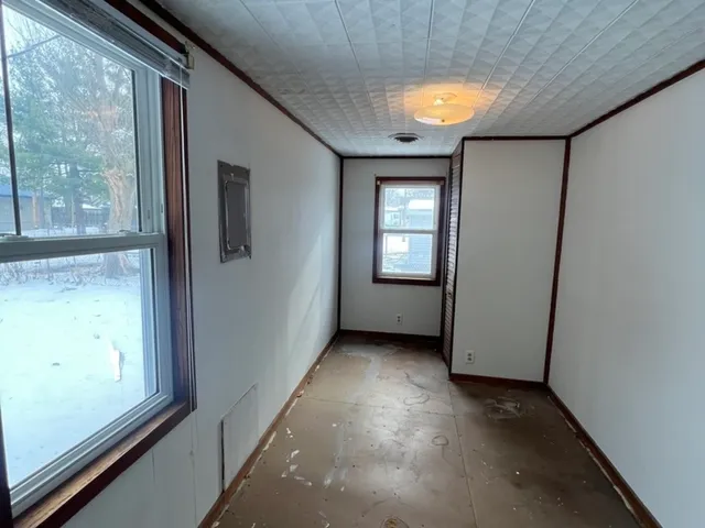 a view of hallway with a large window and doors