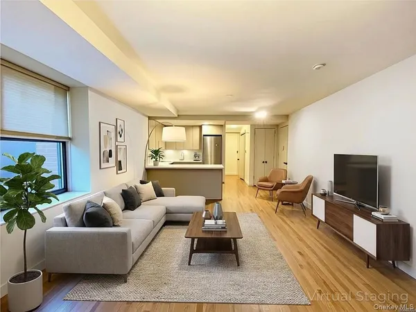 a living room with furniture wooden floor and a flat screen tv