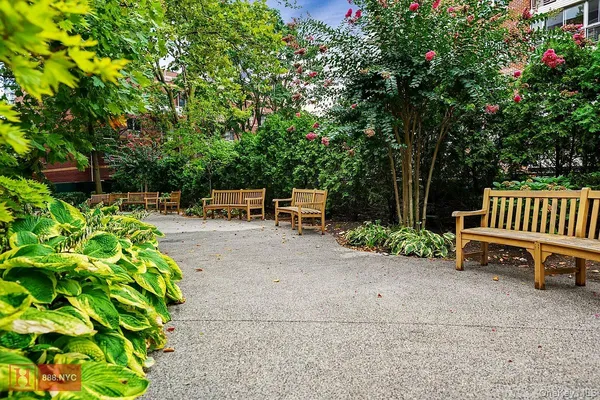 a backyard of a house with a garden and bench