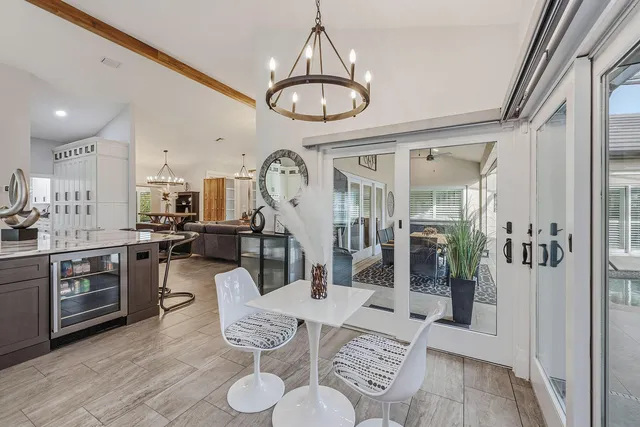 a living room with furniture a rug and kitchen view