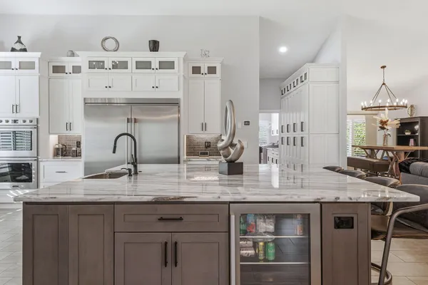 a kitchen with stainless steel appliances granite countertop a sink dishwasher and cabinets with wooden floor