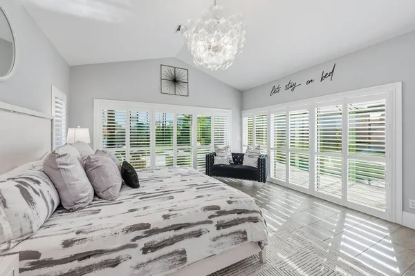 a bedroom with bed and a large window