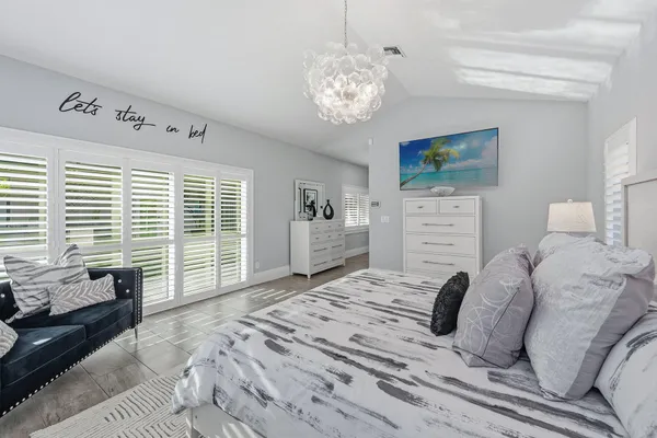a bedroom with a large bed and a window