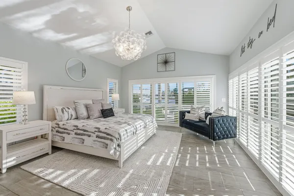a bedroom with a large bed and a large window