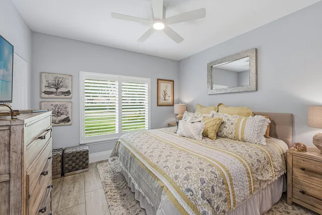 a bedroom with a large bed and a window