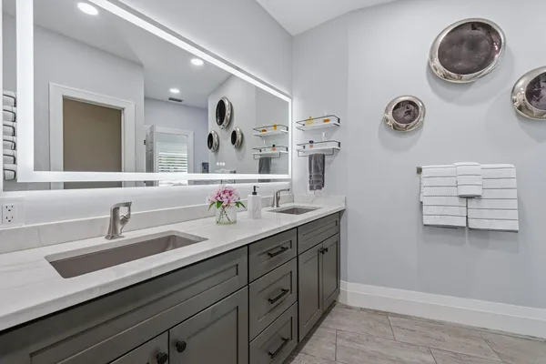 a bathroom with a double vanity sink and a mirror