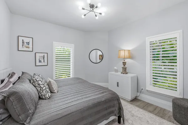 a bedroom with a bed and a chandelier