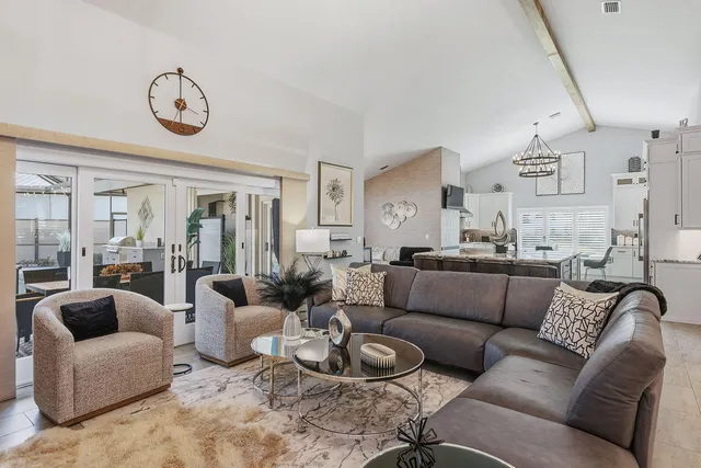 a view of a livingroom with furniture and a large window