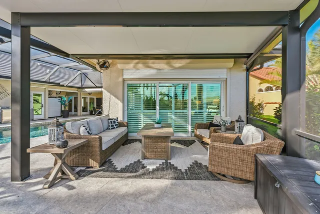 a living room with furniture and floor to ceiling windows