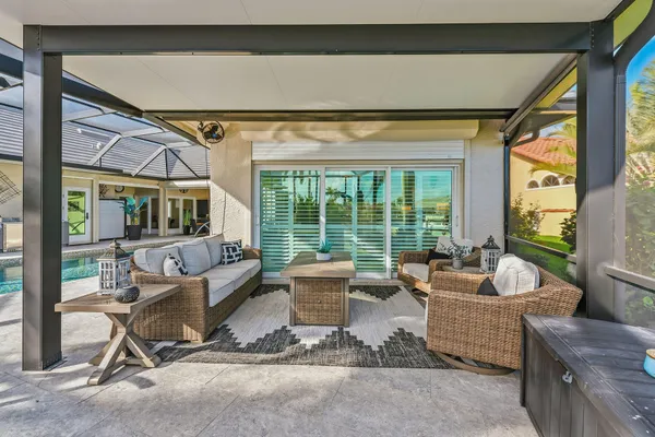 a living room with furniture and floor to ceiling windows