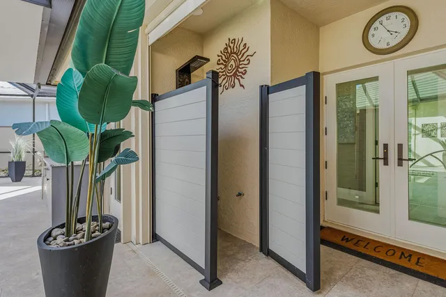 a vase of flowers sitting on a table with a potted plant