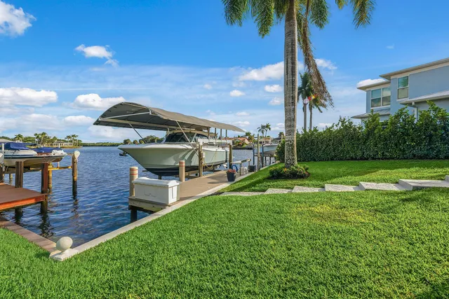 a view of a house with a backyard and a patio