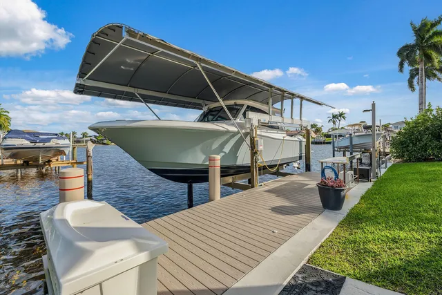 a roof deck with table and chairs under an umbrella