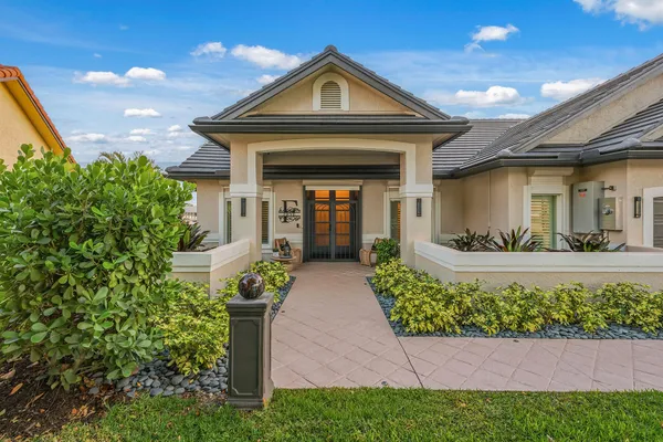 a front view of a house with garden