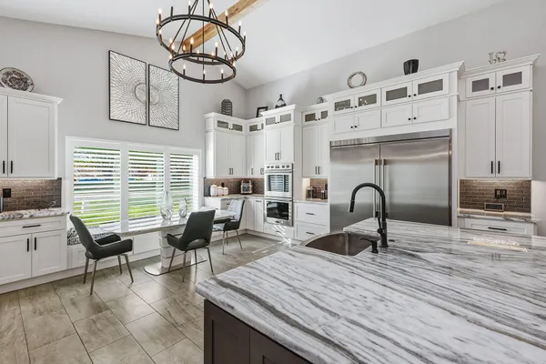 a living room with furniture a dining table and kitchen view
