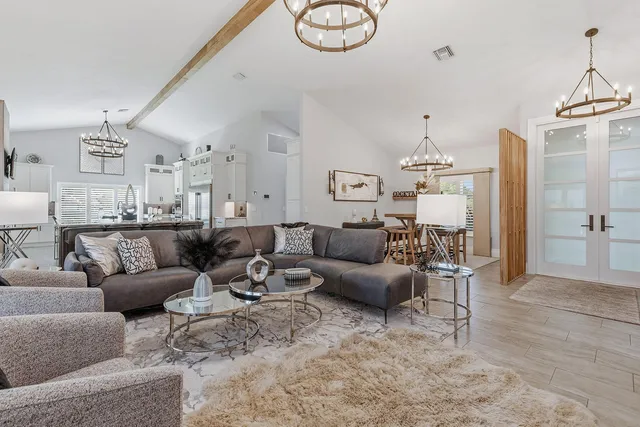a living room with furniture a rug and white walls