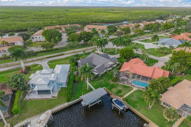 an aerial view of a house with a garden and lake view