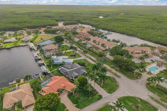 an aerial view of residential houses with outdoor space and trees