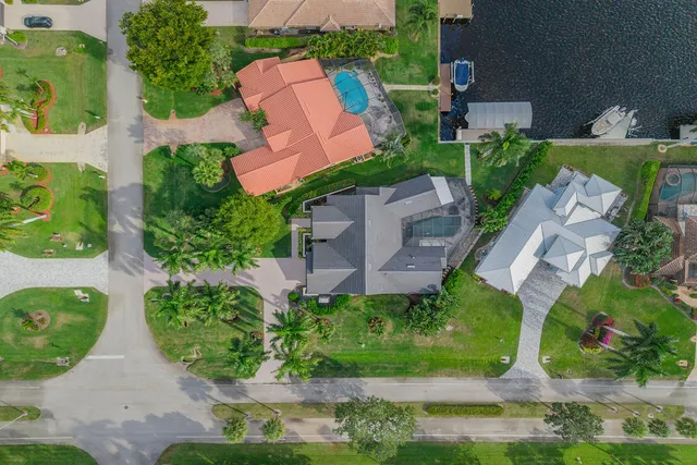 an aerial view of a house with garden space and street view