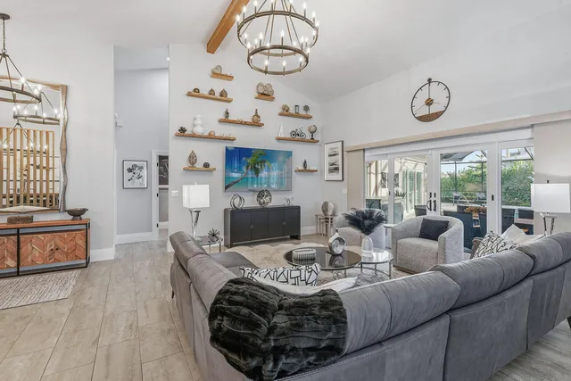 a living room with fireplace furniture and a large window