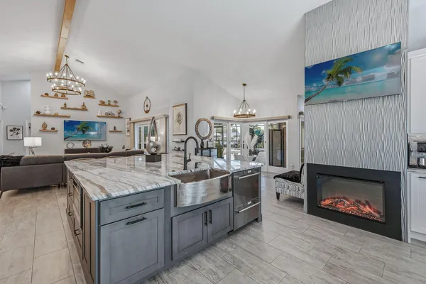 a kitchen with stainless steel appliances granite countertop a stove top oven a sink a counter space and cabinets