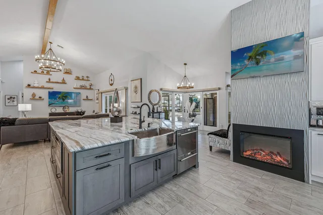 a kitchen with stainless steel appliances granite countertop a stove top oven a sink a counter space and cabinets