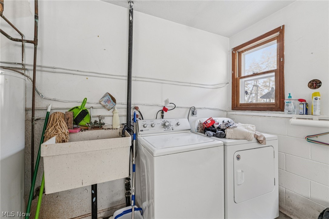 15615 Mason Road Vermilion, OH 44089 - Photo 25 of 34 Laundry area featuring water heater and washer and dryer