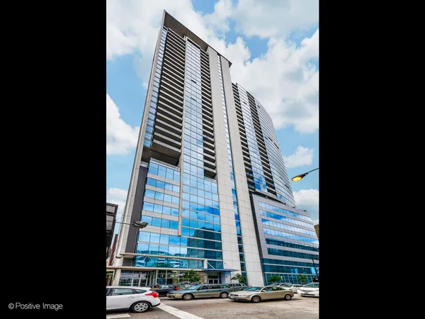 a view of a tall building next to a road