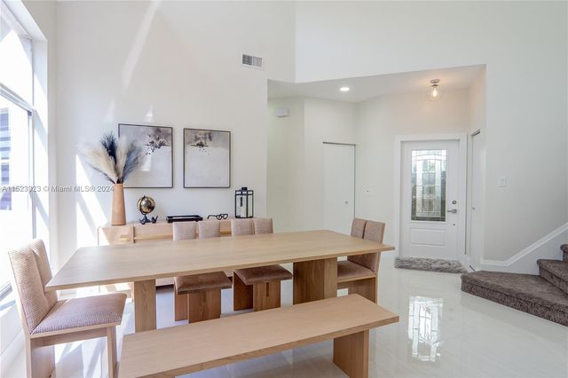 a dining room with a table chairs and chandelier