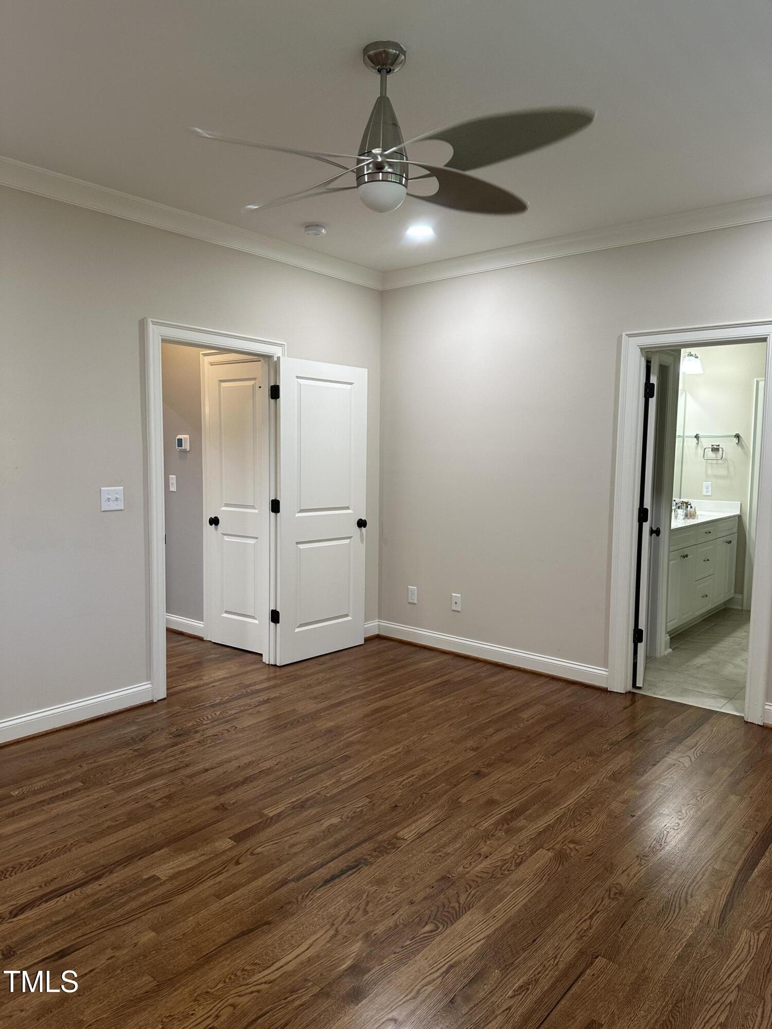 129 Cofield Circle Durham, NC 27707 - Photo 17 of 37 an empty room with wooden floor and mirror